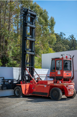 Forklift in outdoor setting, showcasing heavy-duty capabilities and design, relevant to warehouse equipment and operational efficiency discussions.