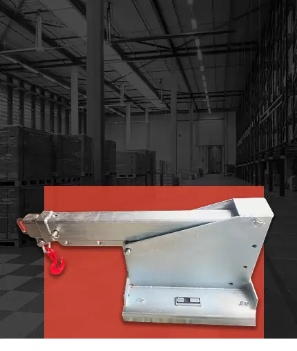 Machine attachment for portable toilets, featuring a metallic arm and hook, set against a warehouse background, emphasizing worksite equipment for sanitation solutions.