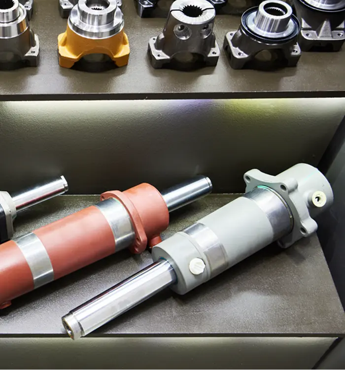 Hydraulic cylinders and components displayed on a shelf, showcasing high-quality forklift hydraulic parts for industrial applications.
