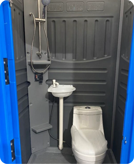 Portable toilet and shower combo unit featuring a showerhead, sink, and ceramic flushable toilet, designed for outdoor hygiene facilities at construction sites.