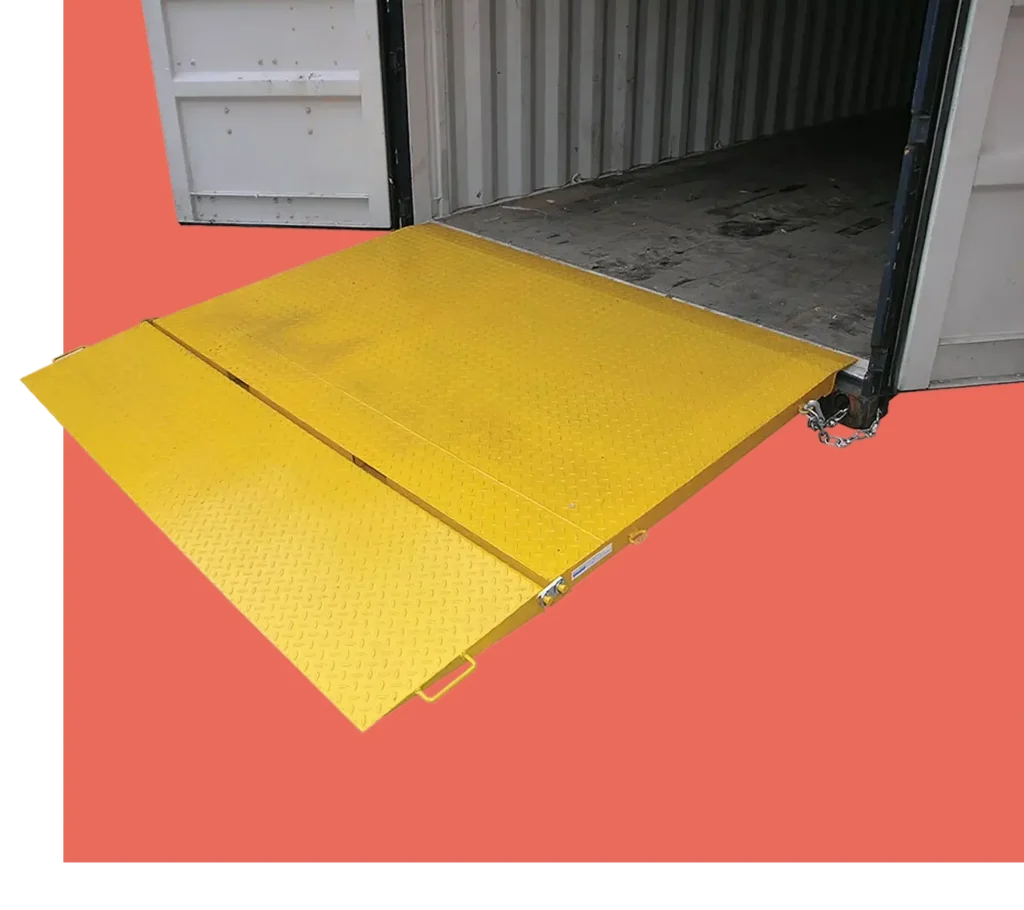 Container ramp with textured surface, yellow color, positioned at the entrance of a shipping container, enhancing safe loading and unloading in industrial settings.