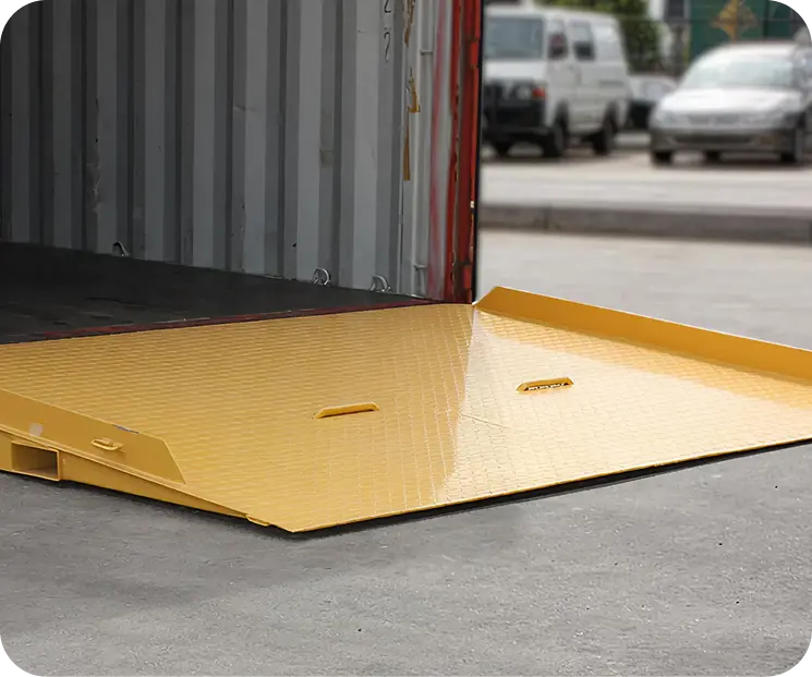 Container ramp with raised side plates, positioned at shipping container entrance, featuring textured surface for traction and safety in industrial loading and unloading operations.