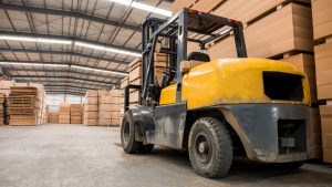 Yellow forklift in a large warehouse. Industry concept.